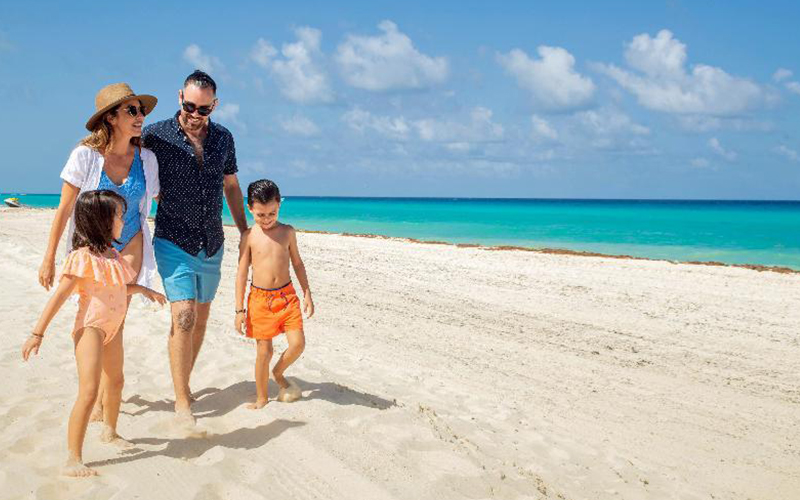Family enjoying a beach in Cancun with children